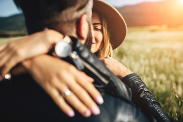 Young couple in leather jackets in the field