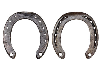 Horseshoe isolated. Close-up of metal horse shoe as a symbol of good luck, prosperity and of a happy future isolated on a white background. Macro photograph. Front and back view.