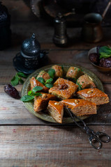 Ramadan kareem with arabic coffee and traditional arabic dessert baklava with honey and nuts. Arabian style. Ramadan breakfast concept.