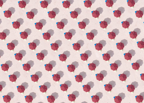 Indonesia, Bali, Aerial view of rows of red beach umbrellas