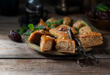 Ramadan kareem with arabic coffee and traditional arabic dessert baklava with honey and nuts. Arabian style. Ramadan breakfast concept.