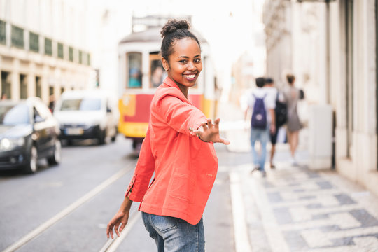 Portrait of happy young woman in the city, Lisbon, Portugal