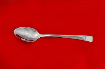 spoon isolated on red background