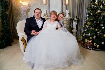 Bride, big fat groom and them teenager son in a nice room