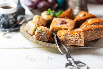 Ramadan kareem with arabic coffee and traditional arabic dessert baklava with honey and nuts. Arabian style. Ramadan breakfast concept.