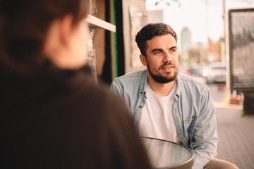 Couple sitting at sidewalk cafe