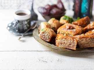 Ramadan kareem with arabic coffee and traditional arabic dessert baklava with honey and nuts. Arabian style. Ramadan breakfast concept.