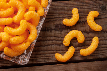 curls snacks on a wooden background