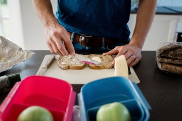 father making a packed lunch for his kids before school