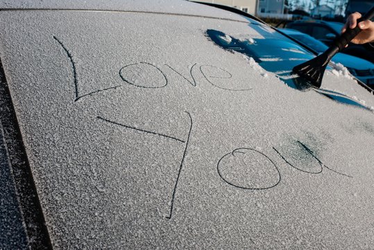 I love you message on the windscreen of a frosty car in winter