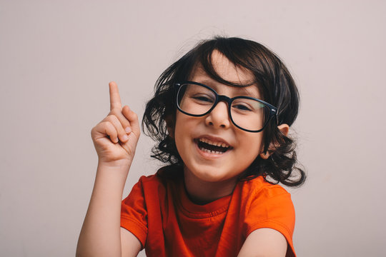 Smiling Little boy raising his hand