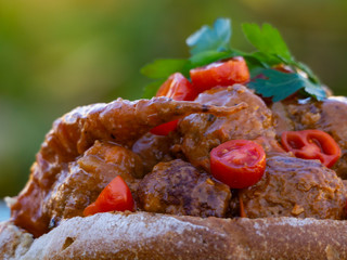 a bread bowl with meatballs