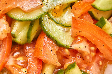 Fresh tomato and cucumber salad close up photo