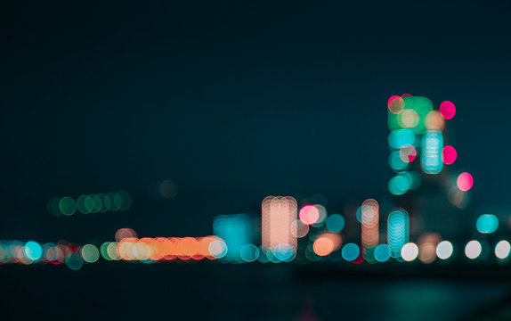 Defocused Image Of Illuminated Lights In City Against Sky At Night