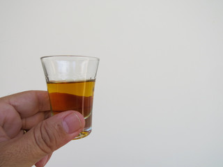 hand holding glass of cachaça with space for text