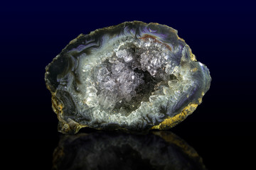 Natural agate druse on dark background macro. Geode, rock