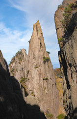 Huangshan Mountain in Anhui Province, China. Rocky pinnacle on Huangshan summit near Flying-Over Rock. View of rocks and cliffs on Huangshan Mountain, China.