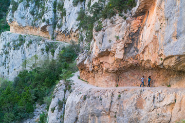 Hiking, Path carved on the rock, Montrebei Gorge - Congost de Mont-rebei, Noguera Ribagorzana river, Montsec Range, The Pre-Pyrenees, Lleida, Catalonia, Spain, Europe