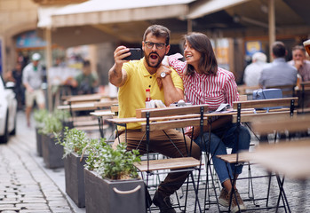 Loving man and woman in a vacation trip making selfie.