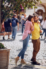  couple enjoying on vacation, young tourist having fun walking and exploring city street during the...
