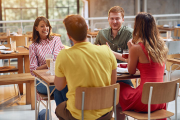 friends having fun a coffee together. people at cafe talking laughing and enjoying their time