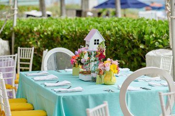 Decorated party table setting  flower arrangements in polka dots jar