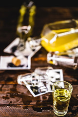 troubled family, social crisis. Photos and memories torn in a glass and spilled drink. Concept of alcoholism or separation, family conflict.