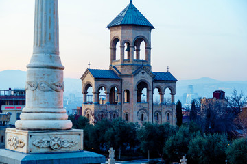 Bell tower at the entrance to the Holy Trinity Cathedral in Tbilisi at sunset
