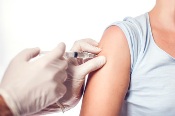 A doctor doing injection to the patient. Isolated. Medicine and healthcare concept