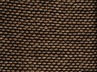 Fragment of knitted scarf of brown-black color with twisted edges. horizontal location on a white background. Close-up