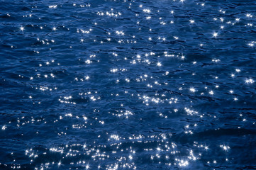 Sun glare on the wavy surface of the sea.