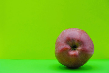 Red apple on neon green background in Ukraine. Health concept. Copy space.  Minimalism.