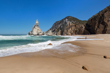 Scenic view of rugged and dramatic coastline with huge boulders at the Praia da Ursa beach near Cabo da Roca, the westernmost point of mainland Europe, in Portugal.