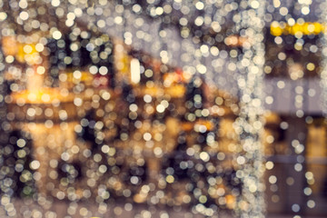 Blur coffee shop or cafe restaurant with abstract bokeh light image background. Abstract blurred coffee shop with bokeh light, warm light tone. For montage product display or design key visual layout