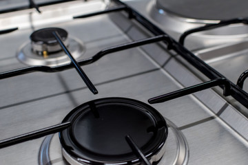 Close up shot of rapid burner on stainless steel gas hob with thin bar pan supports