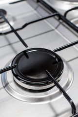 Close up shot of rapid burner on stainless steel gas hob with thin bar pan supports