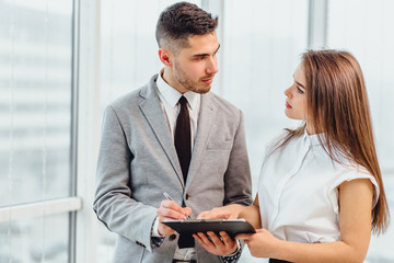 Business people making a deal and signing contract.