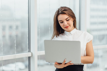 Concentrated entrepreneur working with a laptop in office, trying to find a way to address some problems.