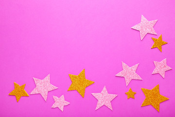 Golden and pink glittering star on pink background