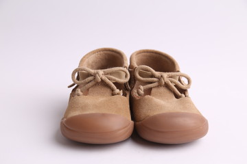 brown leather child shoes in color background