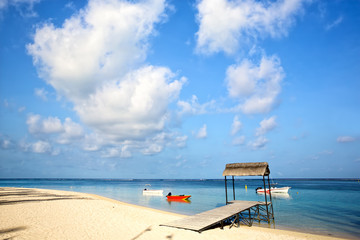 Tropical white beach and jetty, boats n Mauritius