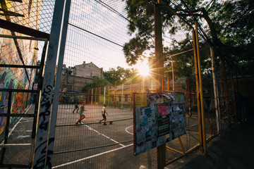 ODESSA, UKRAINE. Children playing soccer at sunset - obrazy, fototapety, plakaty