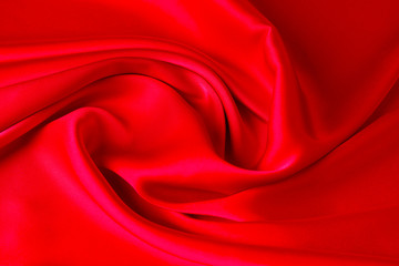 Red ruby color silk fabric background, top view