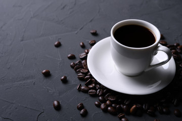 Coffee cup and beans on old grey kitchen beton , rock table. with copyspace for your text