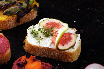 Assorted bruschetta with various toppings. Appetizing bruschetta or brie crostini. Variety of small sandwiches. Mix bruschetta on table