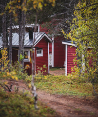 View of Classical swedish Camping site with traditional wooden red cabin cottage houses, Lapland, Northern Sweden