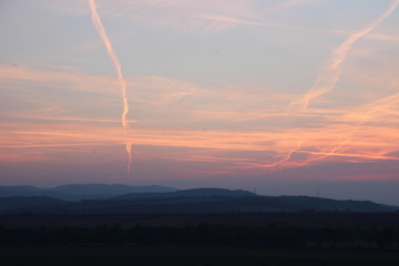 Naklejka na ściany i meble Clouds on Hungarian hills at sunset time.