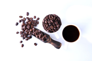Coffee beans and cup of coffee isolated on white background