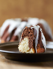 Marble up side down cake with glaze. Concept for a tasty Easter cake. Wooden background.