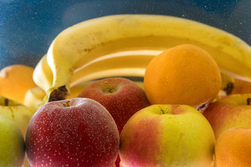 Fruit under water. Fresh fruit. Vegetarianism. Ripe apples, bananas, oranges.